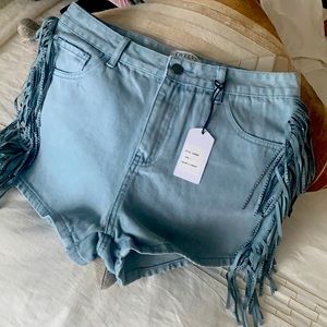 Denim jean shorts with fringe detail.